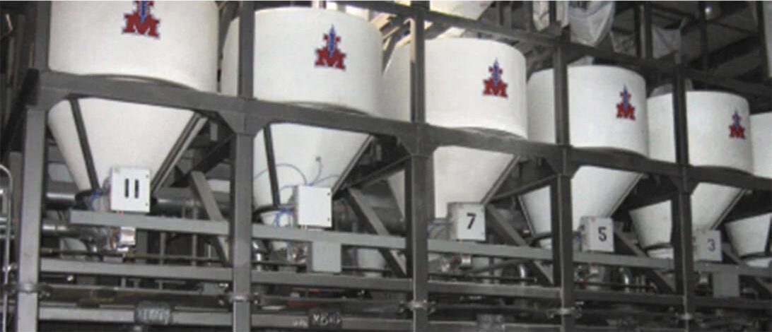 Ingredient Masters dry ingredient batching system installed at Bear Metallurgical, featuring dedicated polyethylene dispensing hoppers.
